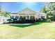 Charming single-story home with a well-manicured lawn, flowerbeds and inviting front porch at 3564 Lower Moncure Rd, Sanford, NC 27330