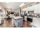 Bright, modern kitchen with stainless steel appliances and a breakfast bar, flowing into the dining and living areas at 3564 Lower Moncure Rd, Sanford, NC 27330