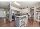 Open kitchen with modern appliances, stylish island, and comfortable barstool seating at 3564 Lower Moncure Rd, Sanford, NC 27330