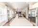 Kitchen island with sink and stainless steel refrigerator in this open-concept home at 3564 Lower Moncure Rd, Sanford, NC 27330