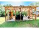 Covered outdoor kitchen featuring a grill, wooden accents, and decor, perfect for entertaining guests at 3564 Lower Moncure Rd, Sanford, NC 27330