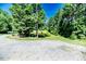 Picturesque property with a scenic pond surrounded by lush greenery and mature trees at 3564 Lower Moncure Rd, Sanford, NC 27330