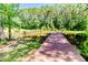 Secluded property featuring a pond with a wooden dock surrounded by beautiful trees at 3564 Lower Moncure Rd, Sanford, NC 27330