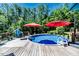 Enjoy the sunny day with this backyard pool surrounded by mature trees and deck at 3564 Lower Moncure Rd, Sanford, NC 27330