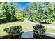 Inviting view of the long driveway leading up to the house, surrounded by lush greenery at 3564 Lower Moncure Rd, Sanford, NC 27330