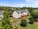 Aerial view of townhomes with lush landscaping, green grass, mature trees and blue sky at 400 Nottinghill Walk, Apex, NC 27502