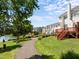 Aerial view of townhomes with lush landscaping, green grass, mature trees and blue sky at 400 Nottinghill Walk, Apex, NC 27502
