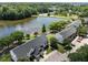 An aerial view showing the townhome in a community with lake, mature trees, and parking spaces at 400 Nottinghill Walk, Apex, NC 27502