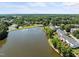 Aerial view of townhomes with lush landscaping and a lake at 400 Nottinghill Walk, Apex, NC 27502