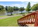 Inviting backyard space with a view of a tranquil lake and a wooden staircase entrance at 400 Nottinghill Walk, Apex, NC 27502