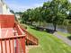 Scenic backyard featuring a deck, stairs leading to a green lawn, a lakeside view, and a walking path, perfect for enjoyment at 400 Nottinghill Walk, Apex, NC 27502