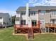 Well-maintained backyard with a red deck, green grass, and easy access to the home at 400 Nottinghill Walk, Apex, NC 27502