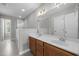 Well-lit bathroom featuring double sinks, a glass door shower, and tile flooring at 400 Nottinghill Walk, Apex, NC 27502