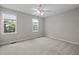 Neutral bedroom with carpet, a ceiling fan and two windows offering ample natural light at 400 Nottinghill Walk, Apex, NC 27502