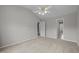 Spacious neutral bedroom with vaulted ceilings, carpet flooring, a ceiling fan and doors to hallway at 400 Nottinghill Walk, Apex, NC 27502