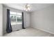 Bright bedroom with a ceiling fan, carpet flooring, and a window overlooking a lake at 400 Nottinghill Walk, Apex, NC 27502