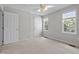 Neutral bedroom with carpet, a ceiling fan, two windows and two entry doors at 400 Nottinghill Walk, Apex, NC 27502
