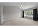 Spacious bedroom with vaulted ceilings, carpet, a ceiling fan and three panel windows at 400 Nottinghill Walk, Apex, NC 27502