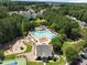 An aerial view highlighting the pool as a central community feature near a playground, tennis courts, and ample green spaces at 400 Nottinghill Walk, Apex, NC 27502