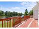 Inviting wooden deck with railing overlooking a serene lake and lush greenery, perfect for outdoor relaxation and enjoyment at 400 Nottinghill Walk, Apex, NC 27502