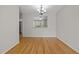 Bright dining room with hardwood floors, a chandelier, and pass-through to another room, perfect for entertaining guests at 400 Nottinghill Walk, Apex, NC 27502