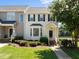 Charming two-story townhome with manicured lawn and beautiful front garden near a serene lake at 400 Nottinghill Walk, Apex, NC 27502