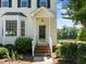 Inviting front entrance with brick steps, detailed doorframe and a view of the lake at 400 Nottinghill Walk, Apex, NC 27502