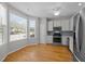 Bright eat-in kitchen with stainless appliances and hardwood flooring at 400 Nottinghill Walk, Apex, NC 27502
