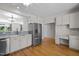 Bright kitchen with stainless steel appliances, desk and hardwood floors at 400 Nottinghill Walk, Apex, NC 27502
