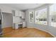 Eat-in kitchen with built-in desk, hardwood flooring, and ample natural light at 400 Nottinghill Walk, Apex, NC 27502