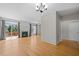 Spacious open-concept living area with fireplace, hardwood floors, and sliding doors to deck overlooking lake, ideal entertaining at 400 Nottinghill Walk, Apex, NC 27502