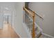 Carpeted staircase with oak banister leading to the second floor at 400 Nottinghill Walk, Apex, NC 27502