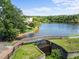 A picturesque view highlights a charming wooden bridge over a serene water feature adding to the community's appeal at 400 Nottinghill Walk, Apex, NC 27502