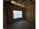 Unfinished interior highlighting wooden framing, window placement and spacious interior at 4026 N Nc 581 Hwy, Kenly, NC 27542