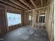 Unfinished interior showcasing wooden framing, window placement, and a spacious layout at 4026 N Nc 581 Hwy, Kenly, NC 27542
