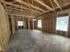 Unfinished room highlighting exposed wooden framing, windows, and concrete flooring at 4026 N Nc 581 Hwy, Kenly, NC 27542