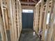 Framed doorway leading to a room; shows construction; exposed wood beams, pipes, and concrete floors at 4026 N Nc 581 Hwy, Kenly, NC 27542