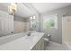 Bright bathroom with a tub-shower combo and a vanity that features modern lighting at 405 E Millbrook Rd, Raleigh, NC 27609