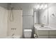 Clean bathroom with a shower-tub combo, modern fixtures, and a well-lit vanity at 405 E Millbrook Rd, Raleigh, NC 27609