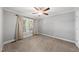 Cozy bedroom featuring neutral walls, plush carpeting, and a ceiling fan for added comfort at 405 E Millbrook Rd, Raleigh, NC 27609