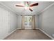 Bright bedroom with a ceiling fan, neutral carpet and paint, and a sunny window at 405 E Millbrook Rd, Raleigh, NC 27609