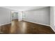 Bright and spacious bedroom featuring gleaming hardwood floors, neutral walls, and ample natural light at 405 E Millbrook Rd, Raleigh, NC 27609
