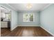 Bright dining area with hardwood floors, natural light, and a view into the adjacent kitchen at 405 E Millbrook Rd, Raleigh, NC 27609