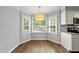 Cozy dining area with beautiful hardwood floors, a modern pendant light, and abundant natural light from windows at 405 E Millbrook Rd, Raleigh, NC 27609