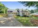 Attractive home featuring a single-car garage, well-maintained lawn, and a classic brick and siding combination at 405 E Millbrook Rd, Raleigh, NC 27609