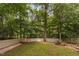 Fenced backyard with mature trees and well-maintained lawn at 409 Englewood Dr, Chapel Hill, NC 27514