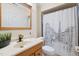 Bathroom featuring a vanity with gold fixtures, a modern toilet, and a shower with a charming Paris-themed curtain at 409 Englewood Dr, Chapel Hill, NC 27514