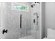 Bathroom with white tile shower, glass door, and modern fixtures exudes clean elegance at 409 Englewood Dr, Chapel Hill, NC 27514