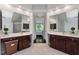 This bathroom has dual sinks with granite countertops, dark wood cabinets and a large mirror at 409 Englewood Dr, Chapel Hill, NC 27514