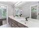 Bright bathroom featuring a double vanity, white countertop, and decorative accents at 409 Englewood Dr, Chapel Hill, NC 27514